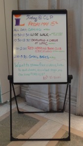 An easel whiteboard with CLP events written on it in different colors