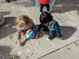 Toddlers drawing with chalk