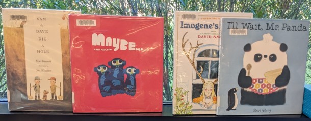 Picture books, covers out, on window ledge