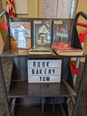 Book cart with BOOK BAKERY YUM sign